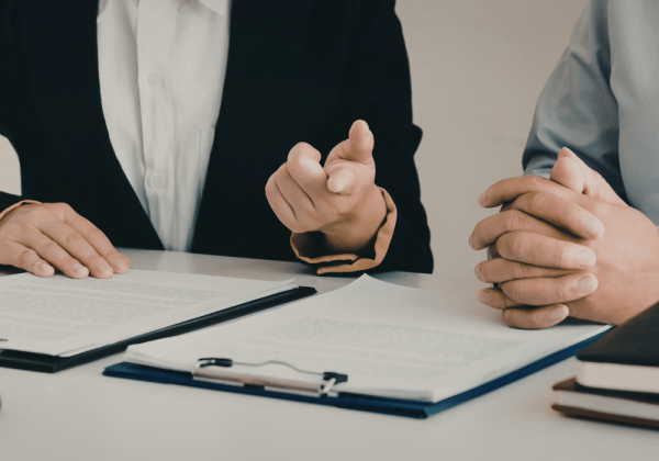 municipal lawyer reviewing documents with client professional municipal law services in ontario